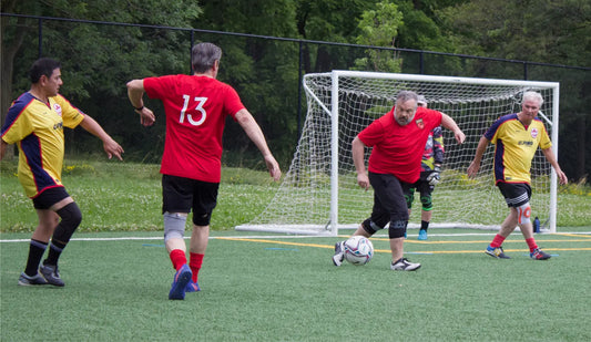 Action from a walking soccer soccer tournament in Canada. One team is wearing red and the other team is wearing yellow