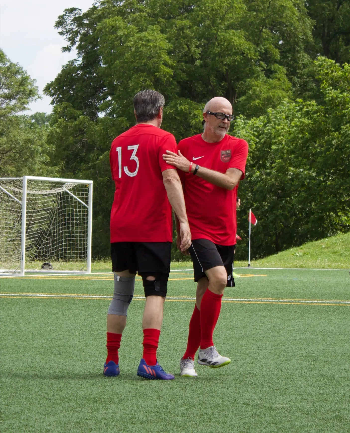 Two Toronto players support each other during a substitution.